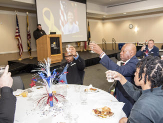 Participants share a toast to POWs