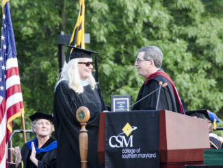 CSM Professor Sandy Poinsett, winner of the Faculty Excellence Award, is congratulated by Faculty Senate President Mike Green