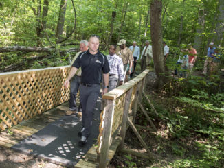 College of Southern Maryland trustees, faculty, staff and community partners explore the new Leonardtown Nature and Fitness Trail this morning at the CSM Leonardtown Campus. The trail is open to the public and offers a 1/3 mile nature walk with signage identifying varieties of trees, new bridges and a rustic bench for resting.